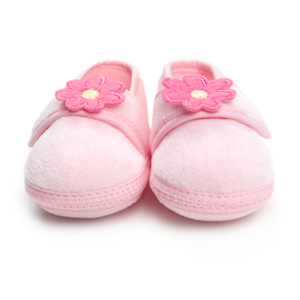 pink baby booties representing surrogacy in Canada